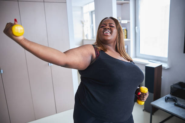 istock Cheerful woman enjoying working out at home 1304566895