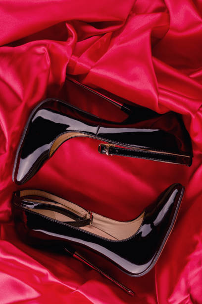 istock Black fetish shiny patent leather stiletto high heels with ankle strap 1304566928