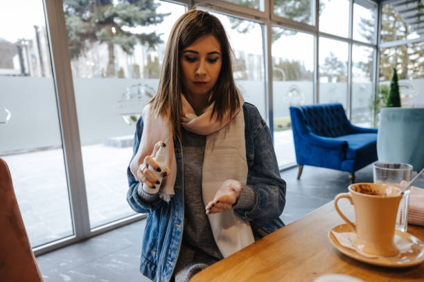 istock Young woman disinfecting hands in restaurant 1304568468