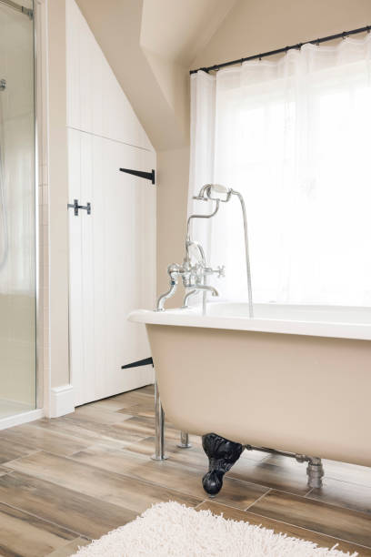 istock Retro bathroom design with roll top bathtub or bath tub, UK 1304568584