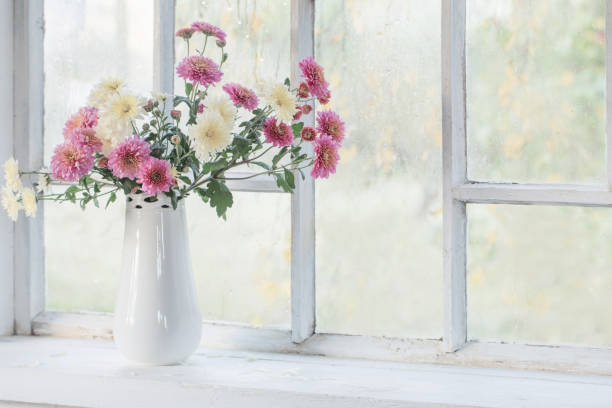 istock chrysanthemums in  vase on  windowsill in autumn 1304569194