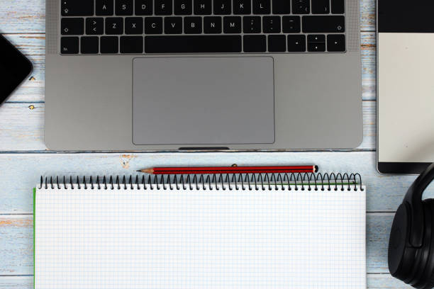 istock Top view of a computer on vintage wooden background 1304571894
