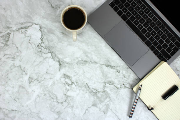 istock Top view of a computer on marble background 1304571903