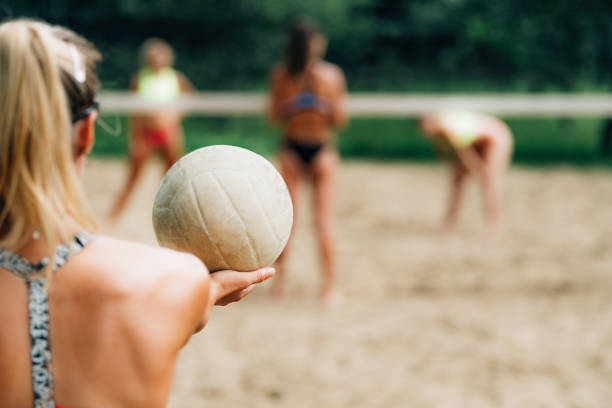 istock Beach Volleyball, Female Player Serving the Ball 1304572451