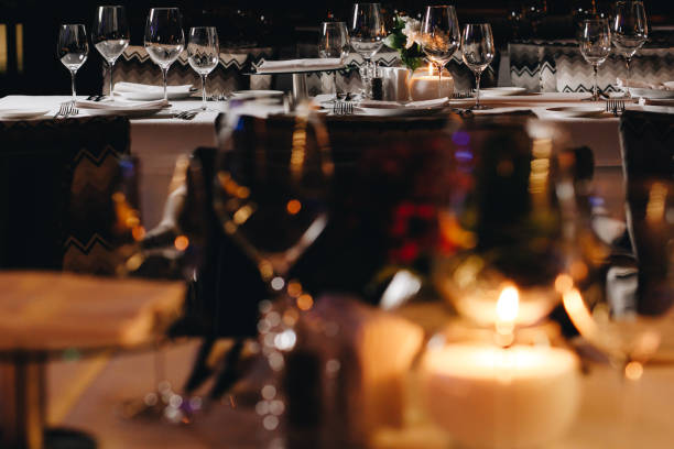 istock tableware Glasses, flower fork, knife served for dinner in restaurant with cozy interior 1304573694