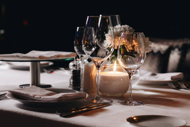 istock tableware Glasses, flower fork, knife served for dinner in restaurant with cozy interior 1304573736
