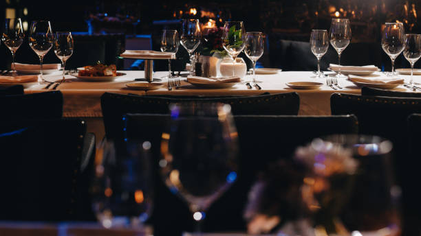 istock tableware Glasses, flower fork, knife served for dinner in restaurant with cozy interior 1304573804