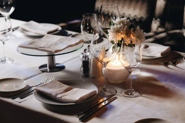 istock tableware Glasses, flower fork, knife served for dinner in restaurant with cozy interior 1304573866