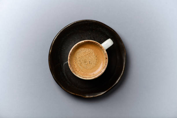 istock Cup of coffee on gray  background. Top view. 1304573903