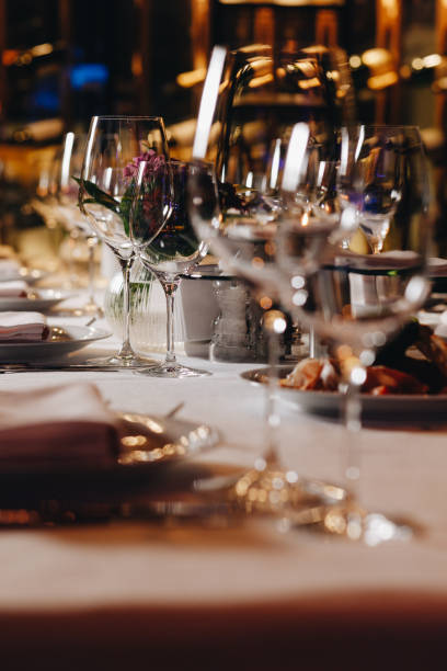 istock tableware Glasses, flower fork, knife served for dinner in restaurant with cozy interior 1304574093