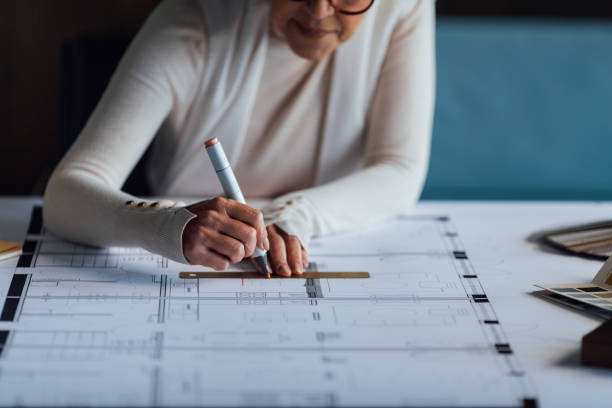 istock Anonymous Female Architect Sitting in her Studio and Creating a Design for New Construction Project 1304574789