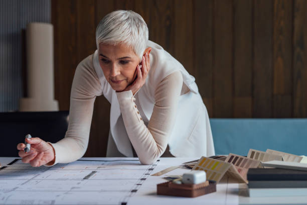 istock Elegant Senior Woman Architect Working on her Project in the Office 1304574812