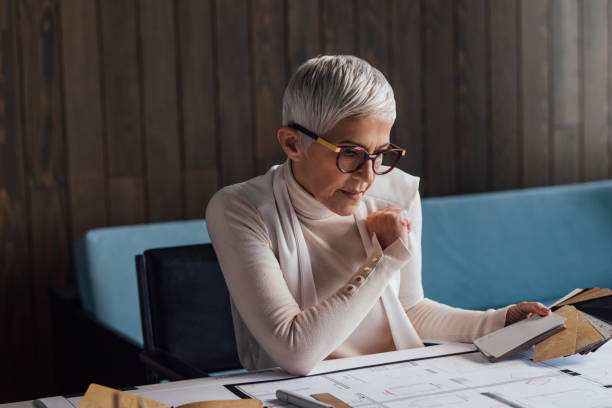 istock Elegant Senior Woman Architect Working on her Project in the Office 1304574826
