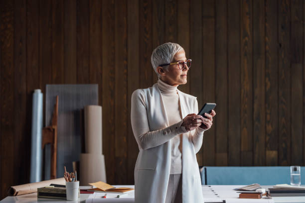 istock Senior Businesswoman Using her Mobile Phone in the Office 1304574828