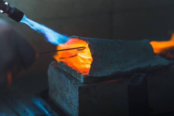istock Melting silver in a jewelry workshop on an open fire. 1304574887