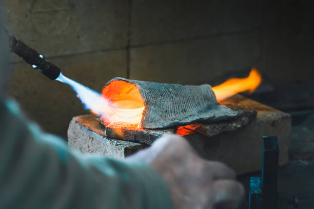 istock Melting silver in a jewelry workshop on an open fire. 1304574888