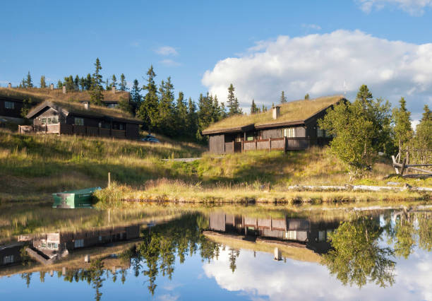 Wooden house reflecting in a lake close to the Norwegian village Aurdal