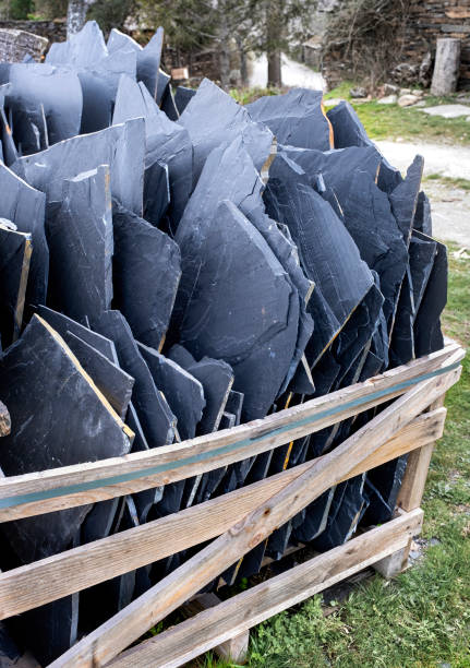 late sheets on a pallet, building material ready to make a house with natural materials, black architecture