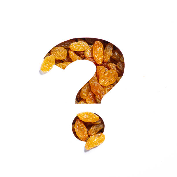 Question punctuation mark of raisins and cut paper isolated on white. Dry berries typeface Question punctuation mark of raisins and cut paper isolated on white. Dry berries typeface. High quality photo carbohydrate food type photos stock pictures, royalty-free photos & images