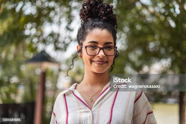 Portrait Of Young Woman Smiling Stock Photo - Download Image Now - One Woman Only, University Student, Diversity