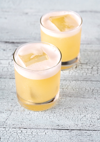 Two glasses of whiskey sour cocktail close up