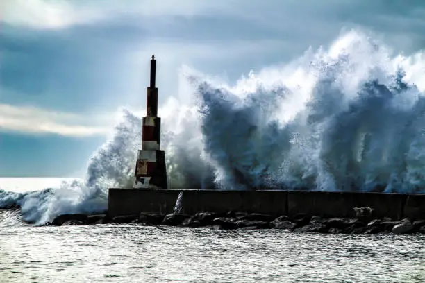 Photo of Giant waves breaking on the breakwater and the lighthouse