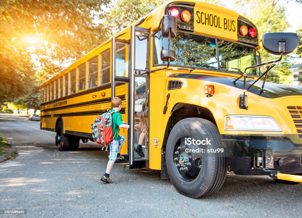 School bus A group of young children getting on the school bus School Bus Stock Photo