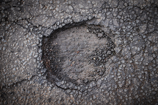 A Dangerous Pothole In A City Street, From Above