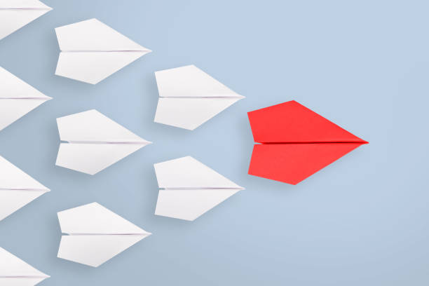 istock Leadership concepts with red paper airplane leading among white 1304589861