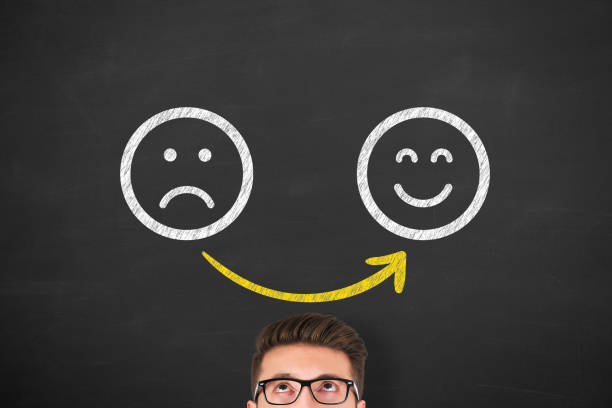 istock Unhappy and Happy over Human Head on Blackboard 1304590945