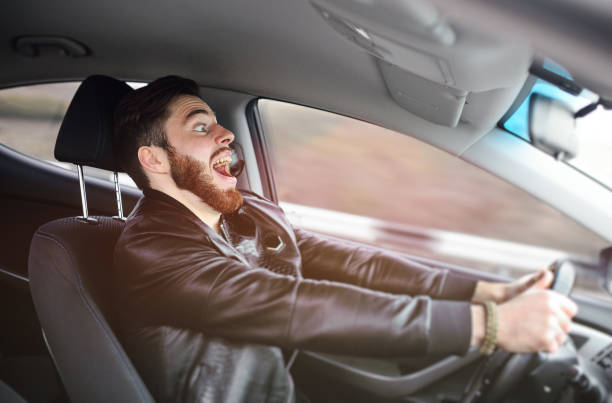 istock Young man scared at the wheel of a car 1304591179