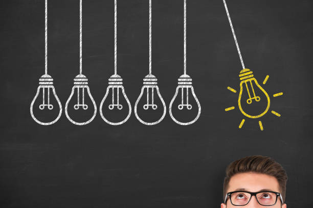istock Creative idea concepts with light bulbs over human head on a chalkboard background 1304591251