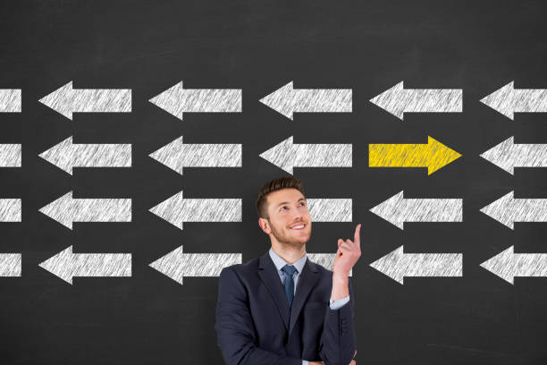 istock Going Your Own Way with Arrows Symbol on Blackboard Background 1304591271