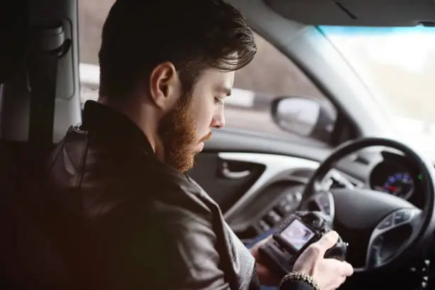 Photo of Young man with a camera in the car