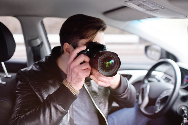 istock Young man with a camera in the car 1304591427