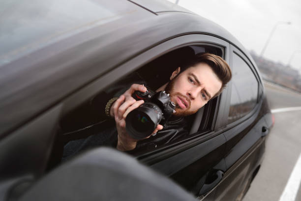 istock Young man with a camera in the car 1304591986