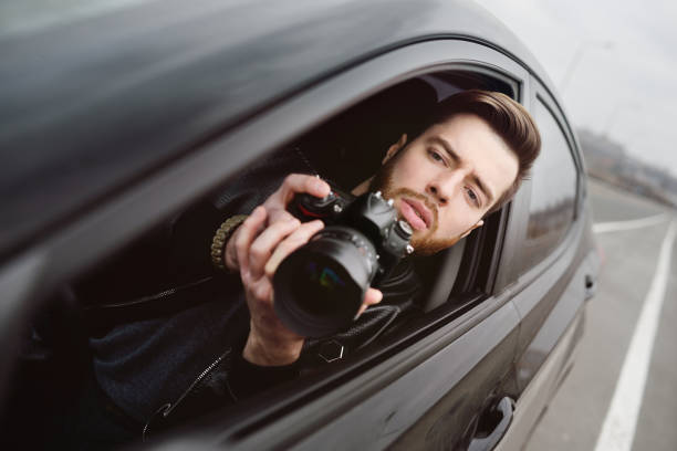 istock Young man with a camera in the car 1304591995