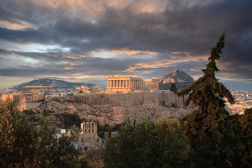 Panoramic iew from the top of Philopappos Hill of the ancient Parthenon, Odeon of Herodes Atticus Theatre and the propylaea gateway on Acropolis Hill at the Greek city of Athens Greece.