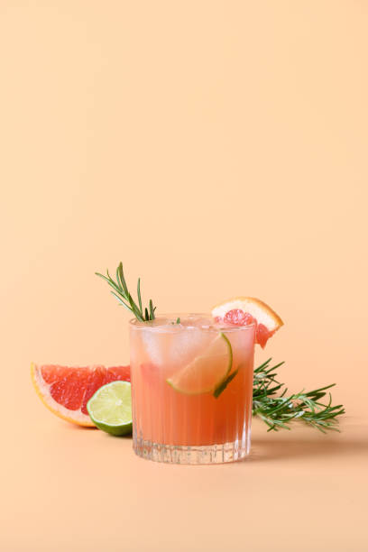 Grapefruit soda with lime garnish rosemary sprig. Mocktail Paloma.
