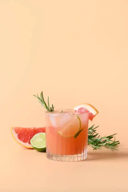 Photo of Grapefruit soda with lime garnish rosemary sprig. Mocktail Paloma.