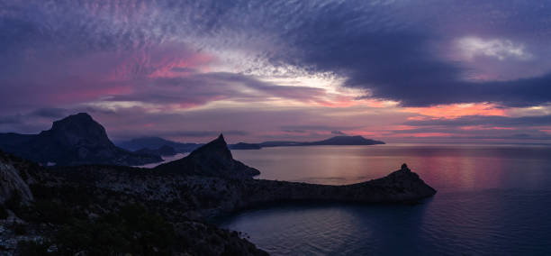 istock Purple dawn over the mountains on the sea 1304597355