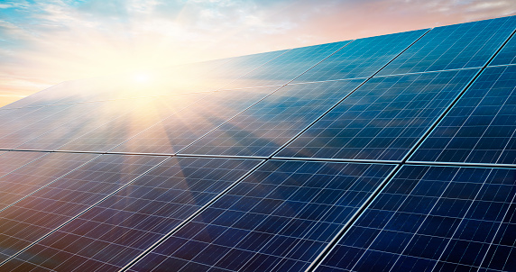 Photovoltaic system in front of a bright sunrise morning sky