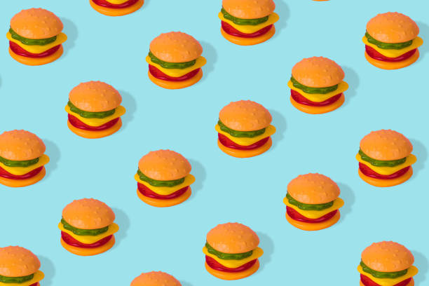 istock Creative trendy idea fast food pattern-  Hamburger on bright blue background. 1304600942