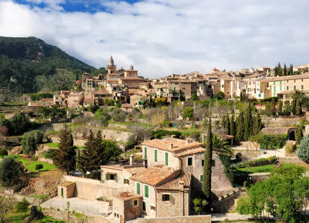 View To The Picturesque Historic Village Of Valldemossa On Balearic Island Mallorca On A Sunny Winter Day With A Few Clouds In The Sky