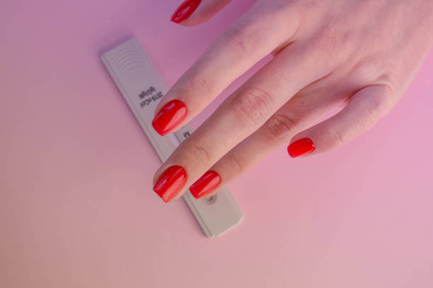 coronavirus test on a pink matte background. medical procedure. medical analysis. bright red manicure next to the covid test coronavirus test on a pink matte background. medical procedure. medical analysis. bright red manicure next to the covid test. diabetes epidemiology stock pictures, royalty-free photos & images