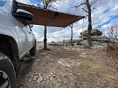 Overlanding campsite with awning in scenic wilderness
