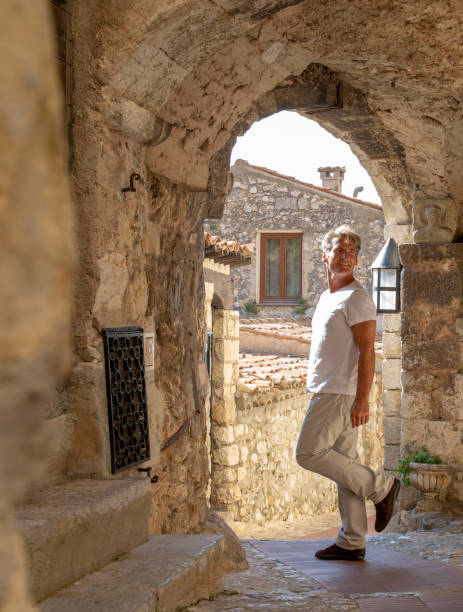 istock Mature man explores streets in old town 1304603863