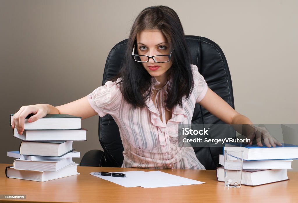 Lady-boss in office Young businesswoman sitting on chair in office File Clerk Stock Photo