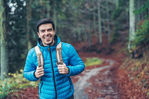 Smiling hiker walking in the mountain