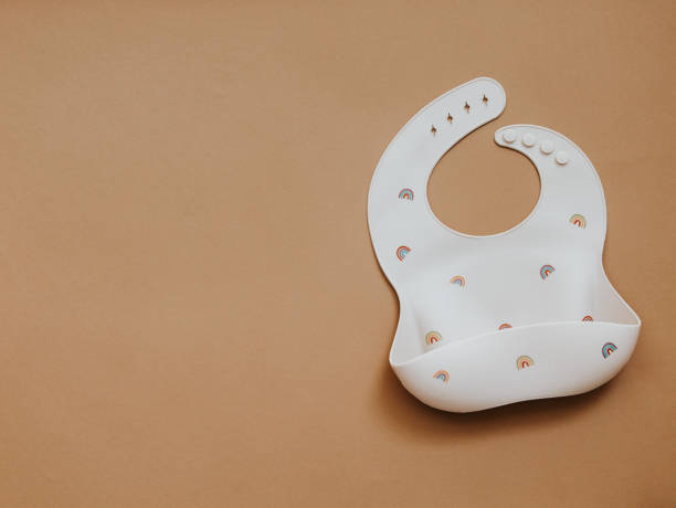 istock Flat lay with cute baby bib on light background. Top view, copy space 1304605168